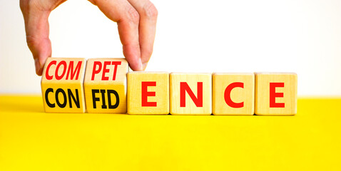 Competence and confidence symbol. Concept word Competence Confidence on wooden cubes. Businessman hand. Beautiful yellow table white background. Business competence confidence concept. Copy space.
