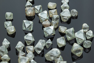 rough diamonds are scattered on black background. High quality photo