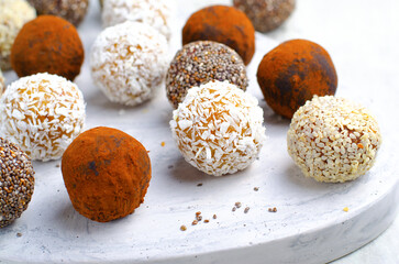 Assorted vegan sweets, Delicious Candy Balls with seeds, dried fruit and cocoa powder, Healthy Candies