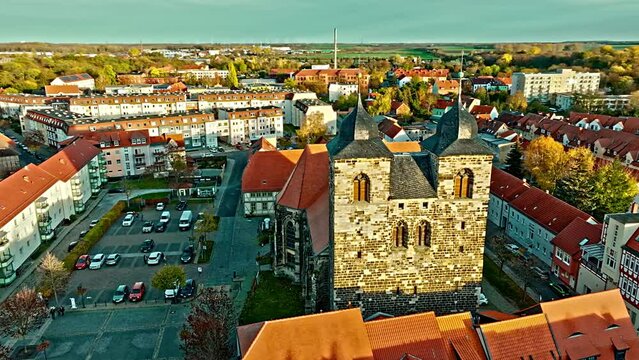 Aerial view of Church of St. Nicolai located in the centre of town near car Parking and houses . Oschersleben(Bode) is a town in the Börde district, in Saxony-Anhalt, Germany.