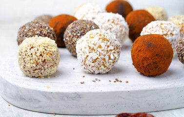 Assorted vegan sweets, Delicious Candy Balls with seeds, dried fruit and cocoa powder, Healthy Candies