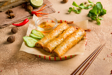 Spring rolls fried with shrimps on brown table