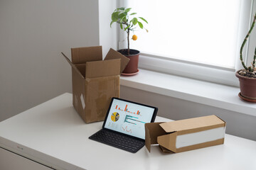 open boxes and a tablet with graphs.