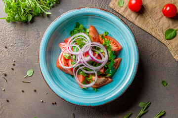 Tomato salad with red onion top view