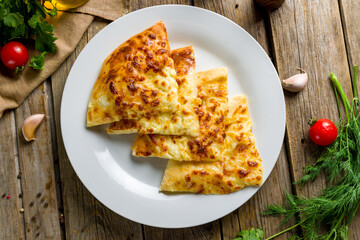 khachapuri with cheese, megrelian khachapuri, georgian cuisine on wooden table  top view