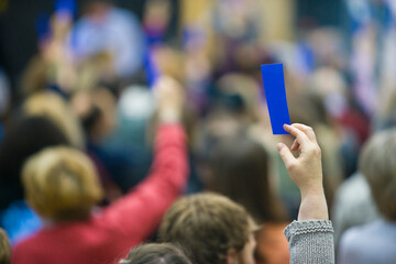 A Hand is raised and counted at a local political rally.