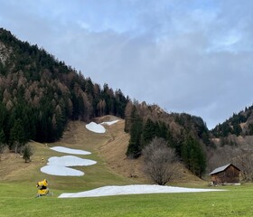 No snow on skiing slopes in winter due to climate change.