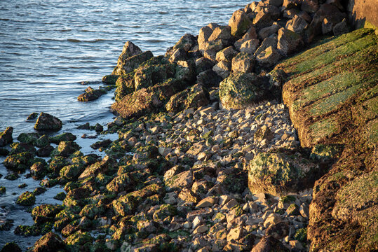 Waves Lapping On Breakwater At Sunset