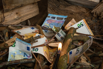 burning money showing waste and loss through negligence bad management and decisions. euro...