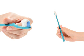 Woman holds toothbrush with toothpaste in her hand isolated on white background.