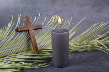Catholic Cross with palm leaf and burning candle. Ash Wednesday, Lent season, Holy Week, Good...