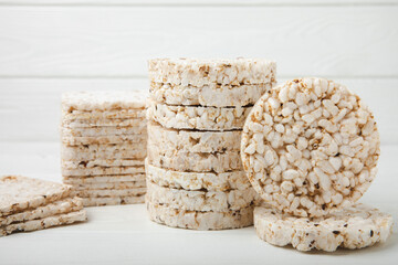 Stack of crispy rice cakes on white texture wood. Diet bread. Diet. proper nutrition. GLUTEN FREE. Copy space. Place for text.