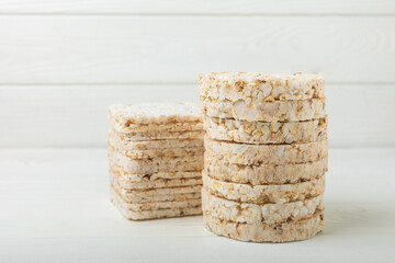 Stack of crispy rice cakes on white texture wood. Diet bread. Diet. proper nutrition. GLUTEN FREE. Copy space. Place for text.