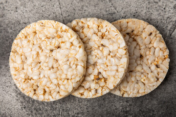 Stack of crispy rice cakes on black textured background. Diet bread. Diet. proper nutrition. GLUTEN FREE. Copy space. Place for text.