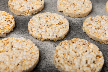 Stack of crispy rice cakes on black textured background. Diet bread. Diet. proper nutrition. GLUTEN FREE. Copy space. Place for text.