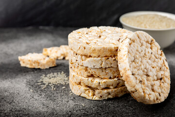 Stack of crispy rice cakes on black textured background. Diet bread. Diet. proper nutrition. GLUTEN FREE. Copy space. Place for text.