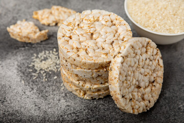 Stack of crispy rice cakes on black textured background. Diet bread. Diet. proper nutrition. GLUTEN FREE. Copy space. Place for text.