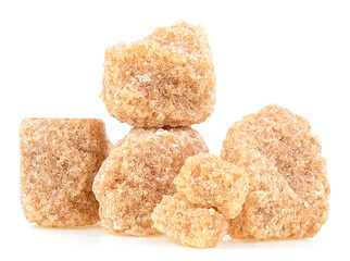 Pile of brown cane sugar pieces isolated on a white background. Unrefined demerara.