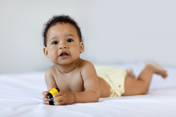Tummy Time. Cute Black Little Baby Lying On Bed At Home