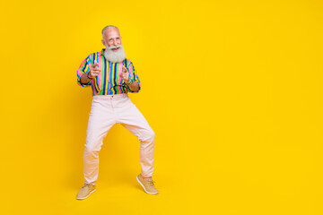 Fototapeta na wymiar Full length photo of impressed funky man wear colorful shirt pointing fingers you empty space isolated yellow color background
