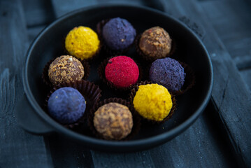 Sweets multicolored round on old wooden background