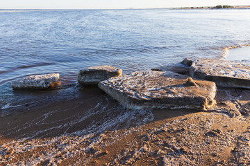 Landscape with dirty melting ice floes on the coast of Baltic Sea