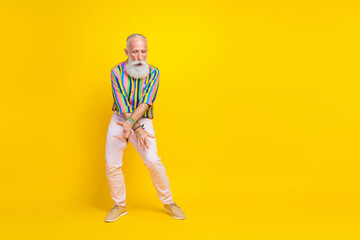 Fototapeta na wymiar Full length photo of excited cheerful man wear colorful shirt having fun empty space isolated yellow color background