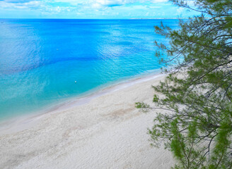 Seven 7 Mile Cayman Islands Beach Grand Cayman white sand blue beach see Caribbean water with green tree