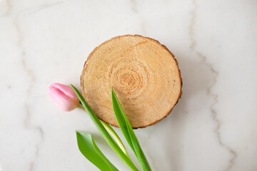 Elegant Tulip Flowers with wooden disk display on marble