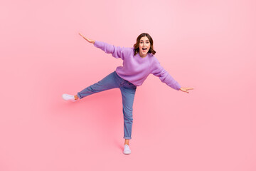 Full length photo of excited cute lady wear violet sweater dancing arms sides having fun isolated...
