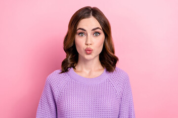 Portrait of satisfied funny positive girl with curly hairdo wear violet pullover pouted lips kiss isolated on pink color background