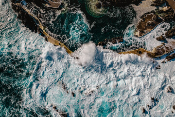 Aerial view of Porto Moniz with volcanic lava swimming pools,Madeira.Saltwater natural pools created in lava formations by Atlantic ocean.Gorgeous views,relaxation,crystal-clear water