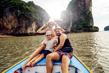 Happy family with one child on the boat trip in Thailand. Tropical summer. Travelers.