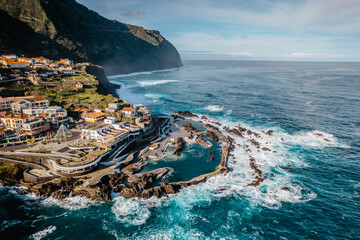Aerial view of Porto Moniz with volcanic lava swimming pools,Madeira.Saltwater natural pools created in lava formations by Atlantic ocean.Gorgeous views,relaxation,crystal-clear water.