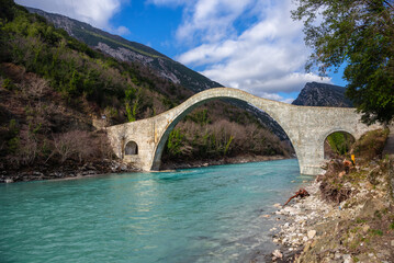 The great arched stone bridge of Plaka on Arachthos river, Tzoumerka, Greece.