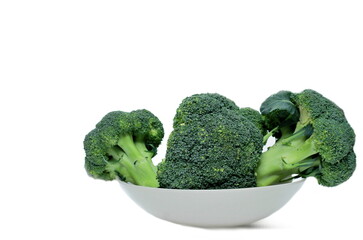 green broccoli uncooked sitting on the table with white background no people stock photo