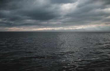rays of sunlight over slightly choppy water