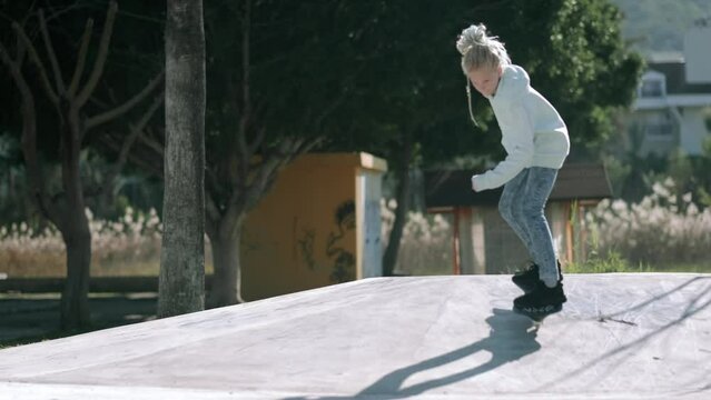 Girl riding on waveboard with two wheels, modern street skate sports of teenagers, casterboard or ripstick for balance ride.