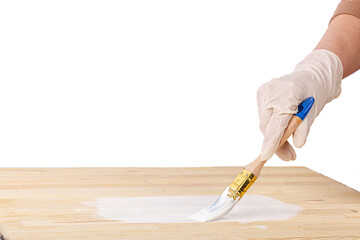 white paint with a brush painting a wooden background with texture