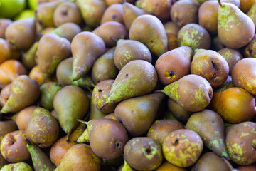 Showcase with fresh organic winter pears in greengrocery