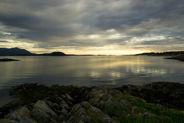 Fototapeta na wymiar The sun sets over a fjord on the Atlantic coast of Norway