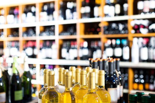 Closeup view on wine supermarket shelves with wide assortment of wine bottles