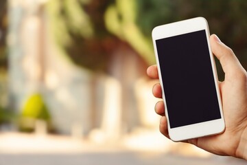 Hands hold a phone with a blank screen