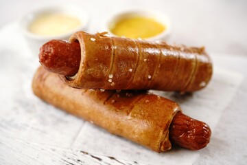Pretzel hot dogs served with sauce, selective focus - Game day snacks