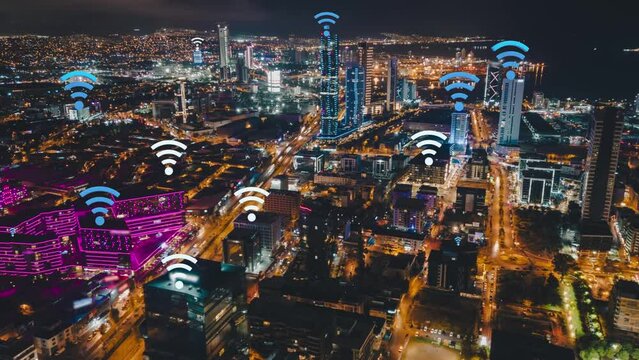 Forwards fly above city. Hyper lapse shot on skyscrapers in distance. Wifi symbols representing communication access points on buildings. Izmir Turkey. High quality 4k footage