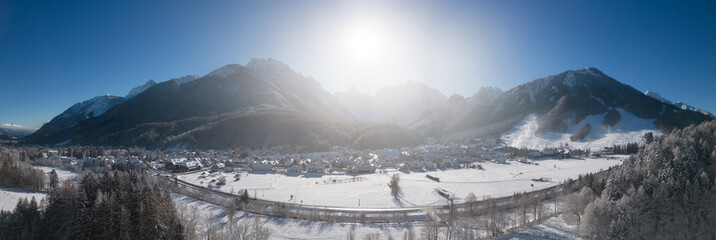 Panorama of skiing town Kranjska Gora in Slovenia covered in snow on a cold sunny winter morning.