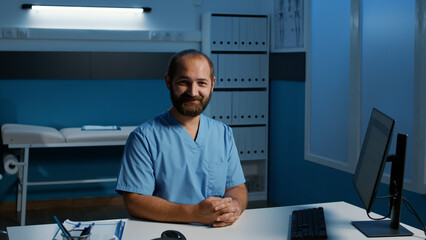 Practitioner nurse sitting at desk working over hours at medical expertise on computer in hospital office, planning patient healthcare treatment to help cure disease. Medicine service and concept