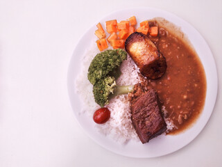 Top view  of Typical Brazilian meal called Prato Feito at on background 
white with space to text