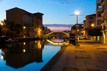 Fototapeta na wymiar Photo of French city Frejus in evening with view of Reyran River and residential buildings.