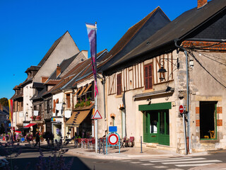 Fototapeta premium Scenic view of historic central street in small French township of Aubigny-sur-Nere with medieval half-timbered houses on summer day, Cher department